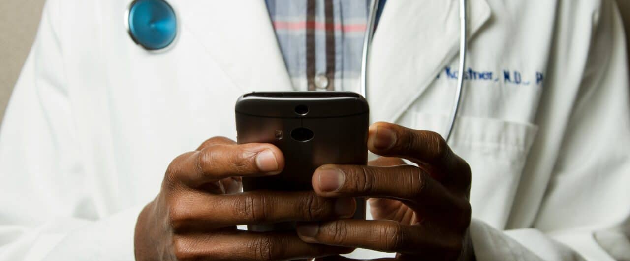 black male doctor on phone