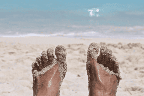 Feet covered in sand