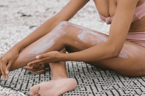 Individual applying sunscreen to skin