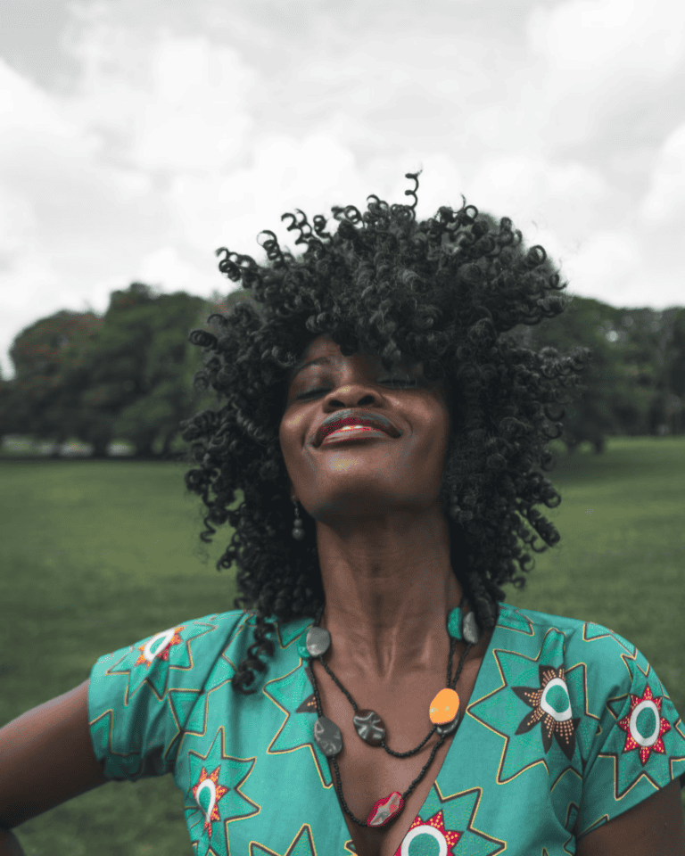 Individual with curly hair outdoors