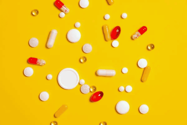 Pills against yellow background