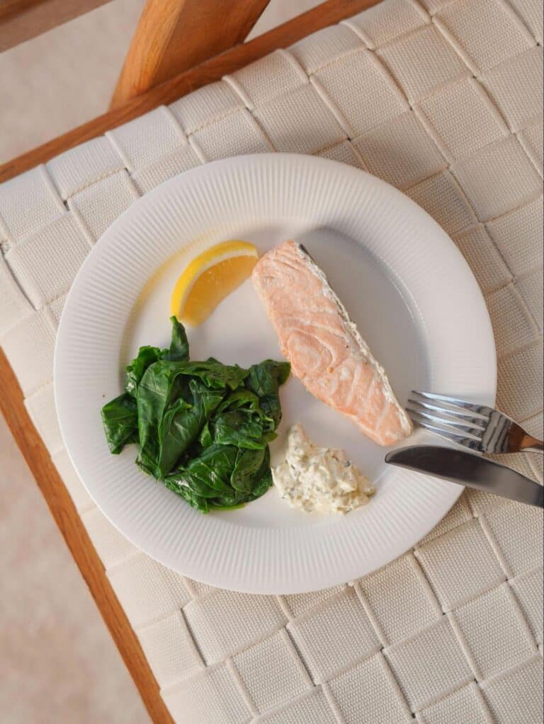 Salmon with Spinach on White Plate