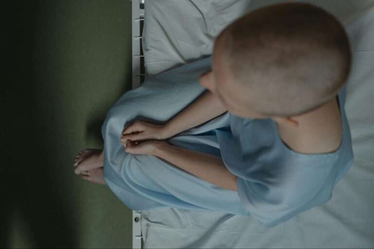 Cancer Patient Sitting on Bed